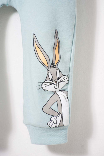 CONJUNTO DE LOONEY TUNES CON PANTALÓN MARFIL Y AZUL BEBÉ UNISEX